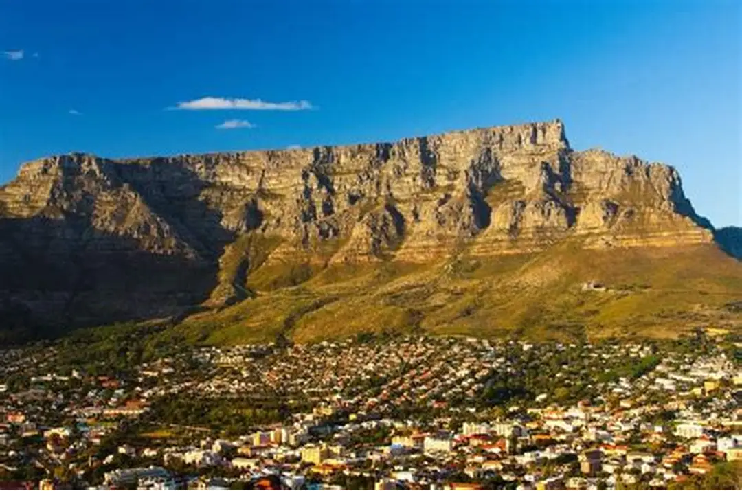 Núi Bàn phẳng đỉnh nổi bật trên nền trời xanh phía trên khu dân cư Cape Town